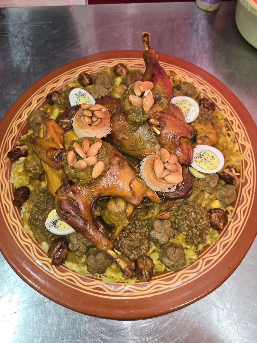 Details of a chicken rfissa platter with lentils, eggs and almonds