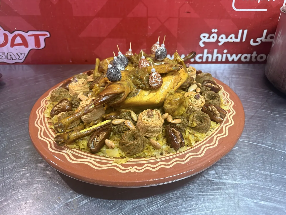 Close-up of a chicken rfissa platter with lentils and nuts from Chhiwat Oum Qusay